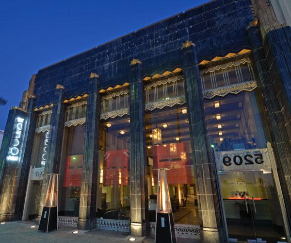 The Deco building at night with lights on