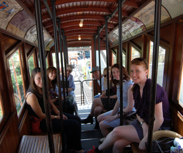 Group of smiling people riding Angels Flight in downtown L.A.